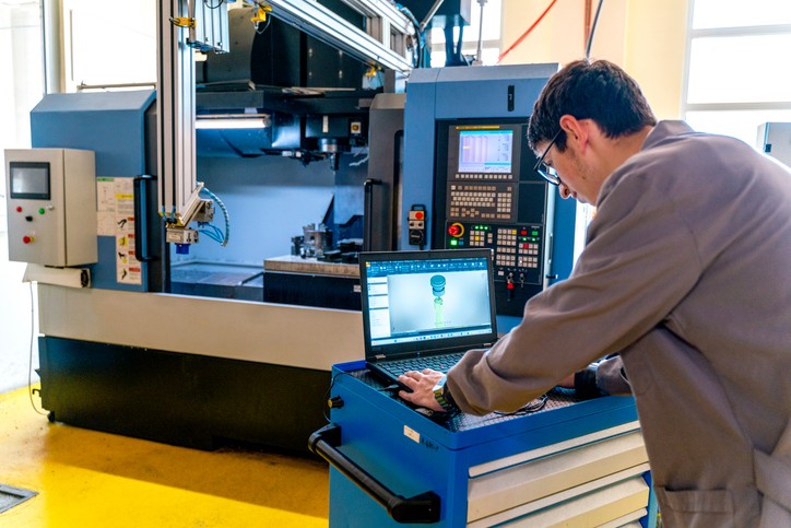 Young Student in Technical Vocational Training with A CNC Machine At School