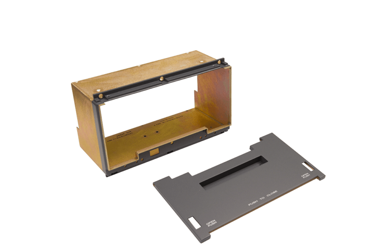 Ruggedized dip-brazed enclosure with removable cover panel, featuring precision-machined gold anodized aluminum housing and black access panel designed for aerospace applications.