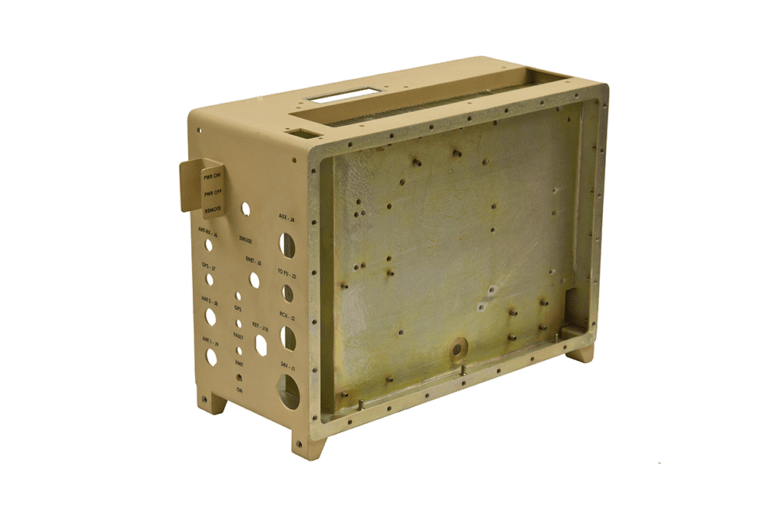 Precision-engineered dip-brazed aluminum enclosure with beige anodized finish, featuring labeled control panel cutouts, strategic mounting points, and reinforced framework designed for defense electronics applications.
