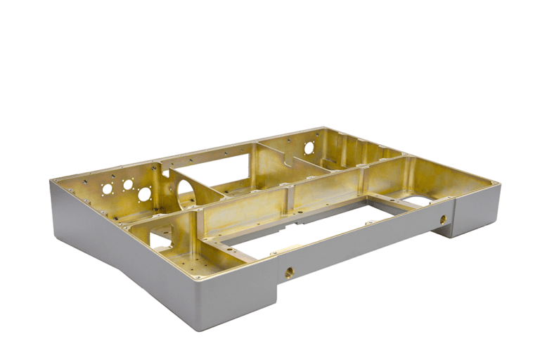 Interior view of precision-manufactured aluminum enclosure with silver exterior and gold chromate protective coating, showcasing multi-chamber design with strategically positioned access ports and mounting interfaces.