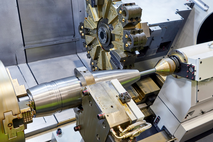 Military metal projectile shell on a lathe machine