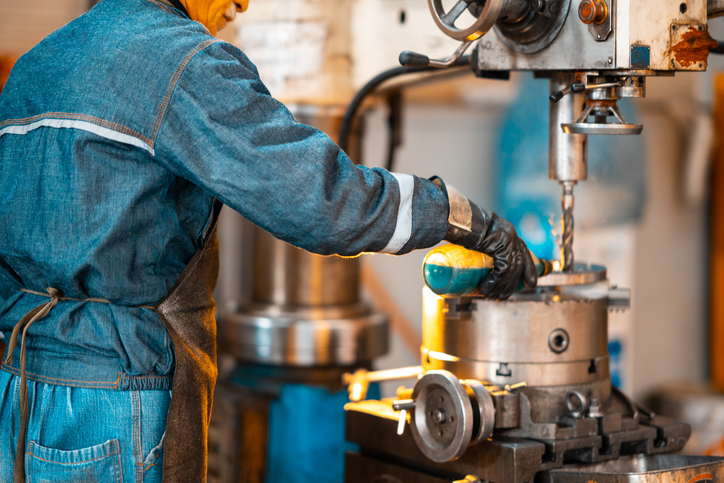 Worker at the lathe machine